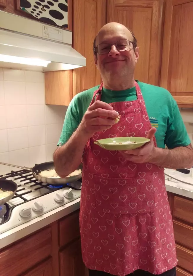 Terry Carmen doing two of his favorite things: cooking and eating!